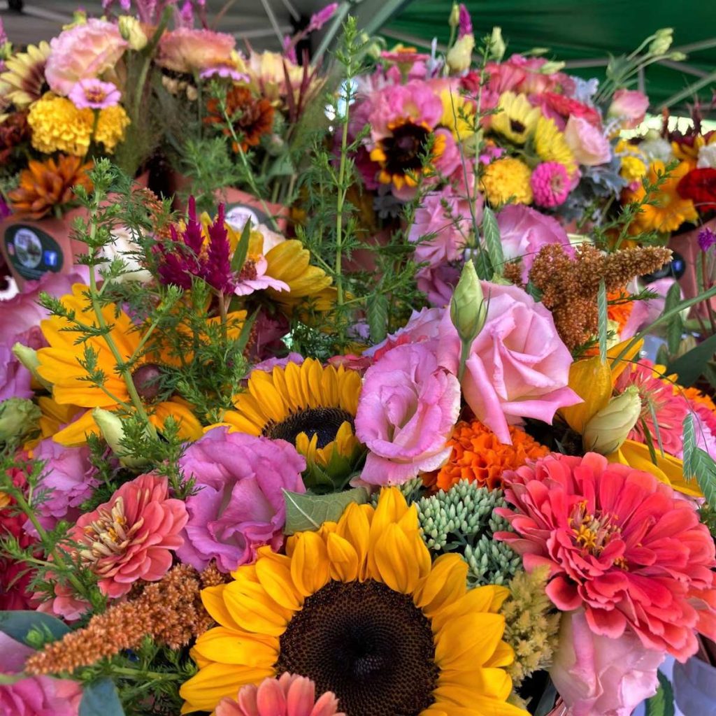 close up of colorful flower bouquets with sunflowers and zinnias