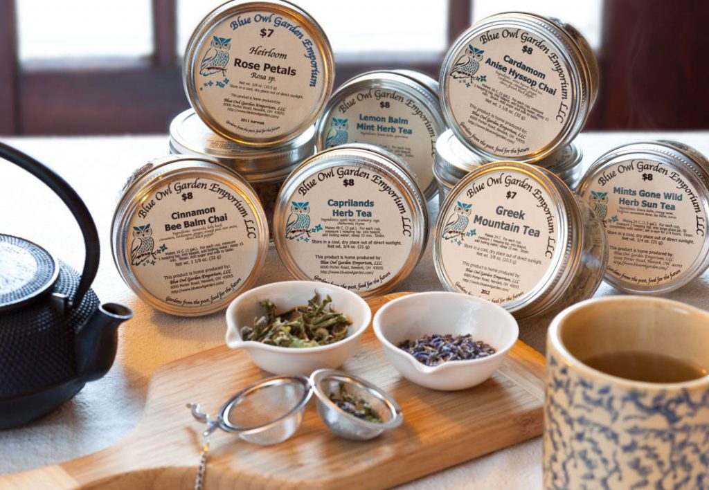 Display of Blue Owl Caprilands Teas with small bowls of tea leaves in front of them