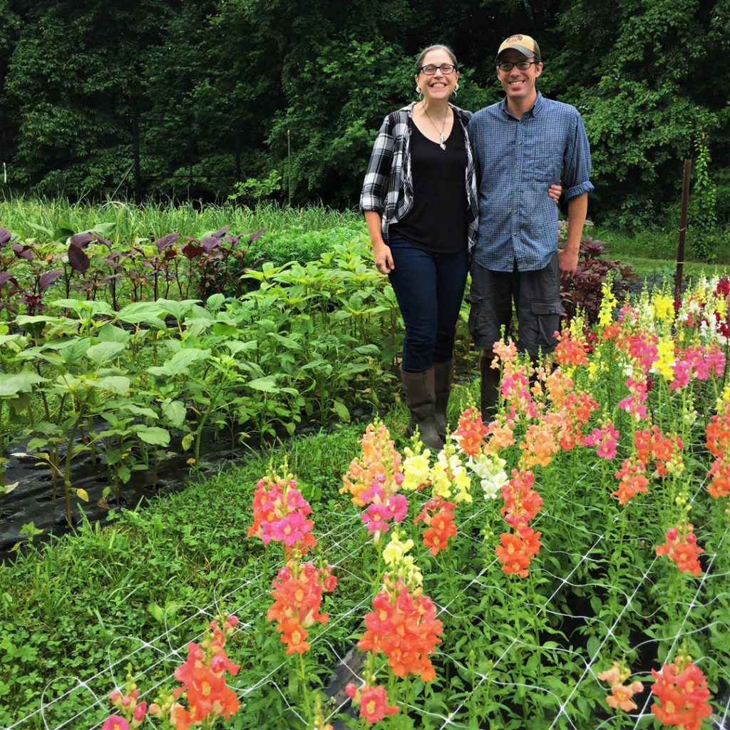 Owners of Down The Road Farm standing near their flower field