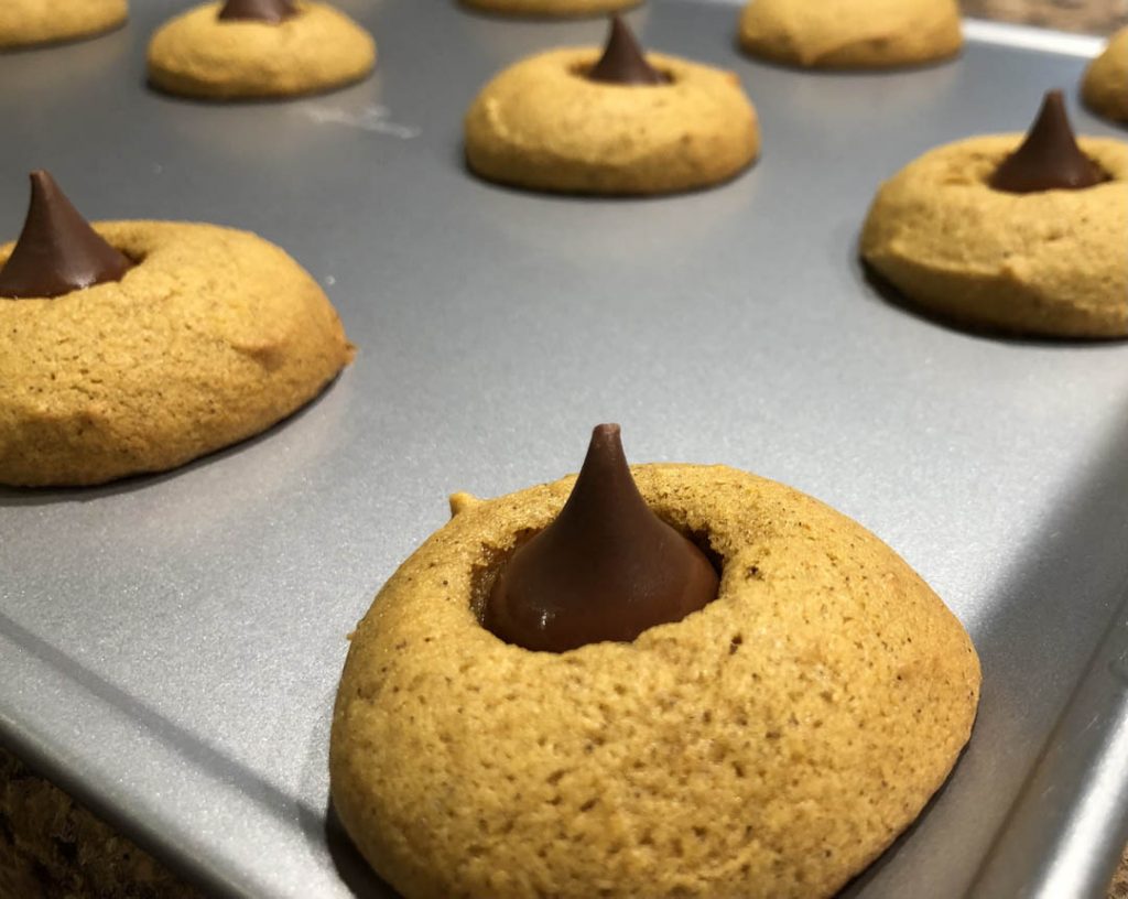 Close up of Faithfully Sweet Bakery peanut butter chocolate kiss cookies on metal baking tray