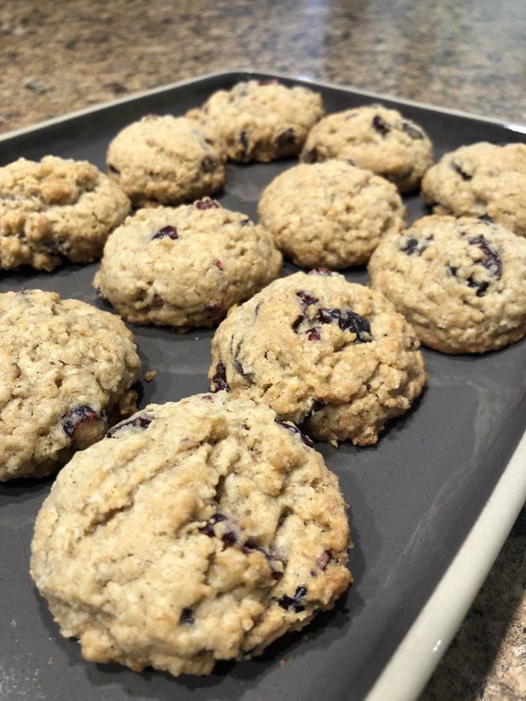 Oatmeal cookies with raisins on metal baking tray by Faithfully Sweet Bakery