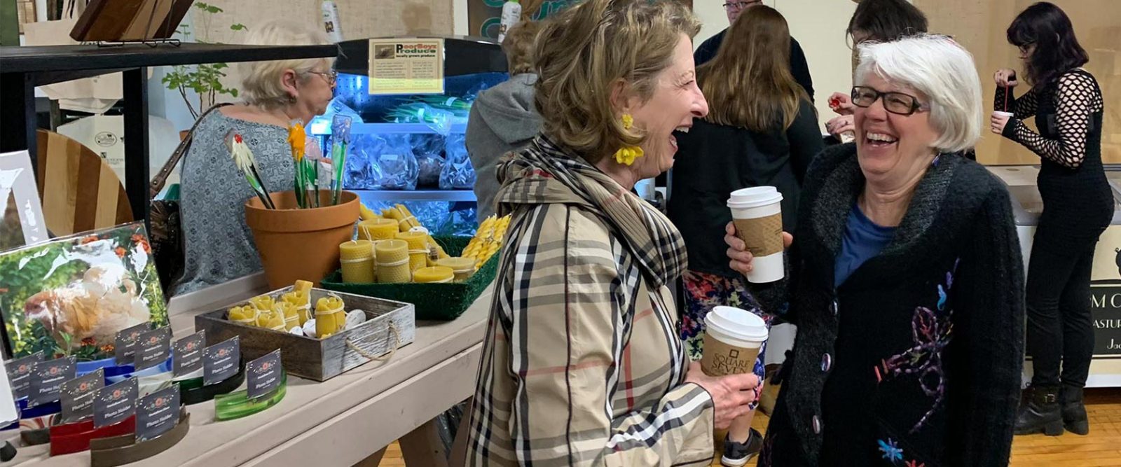 Two women sharing a laugh inside Keller Market House