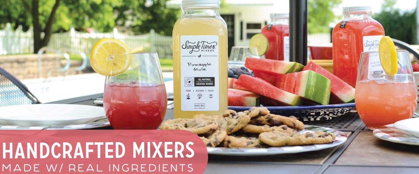 Summer table set with fresh fruits and a bottle of drink mix