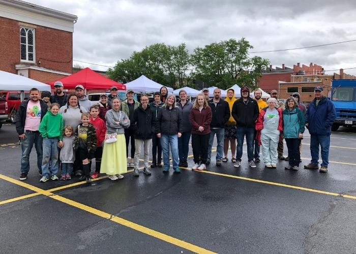 group of farmers market vendors standing in parking lot