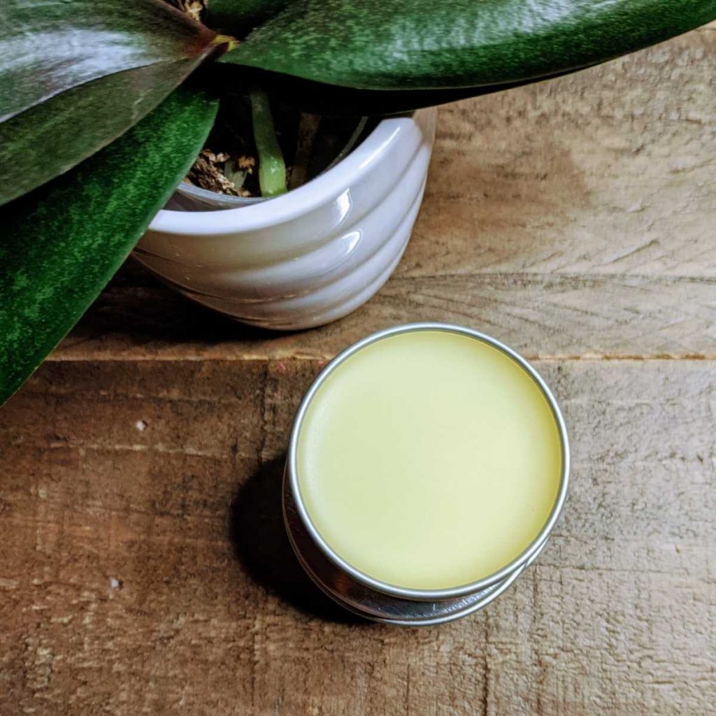 open tin of body care balm