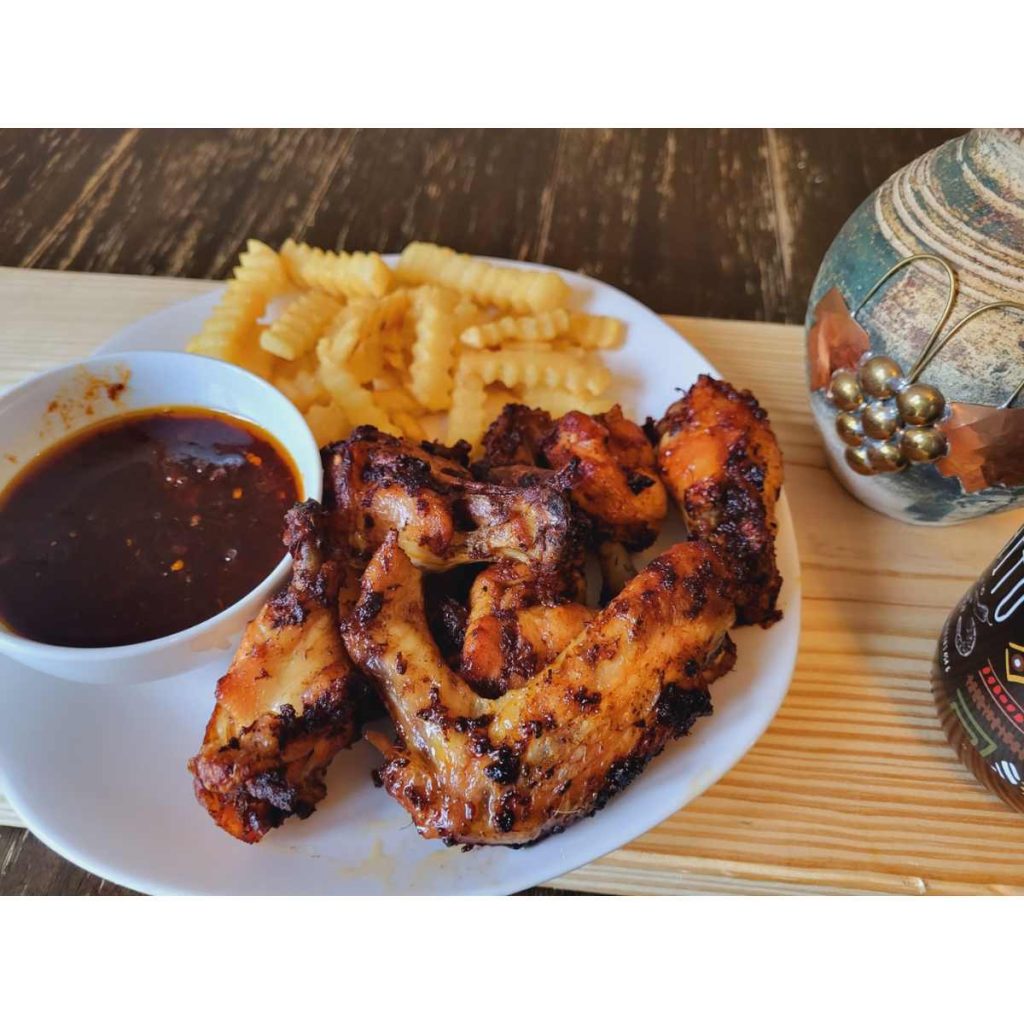 chicken wings with french fries and shito hot sauce