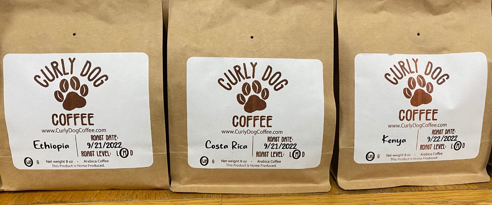 three bags of curly dog coffee beans