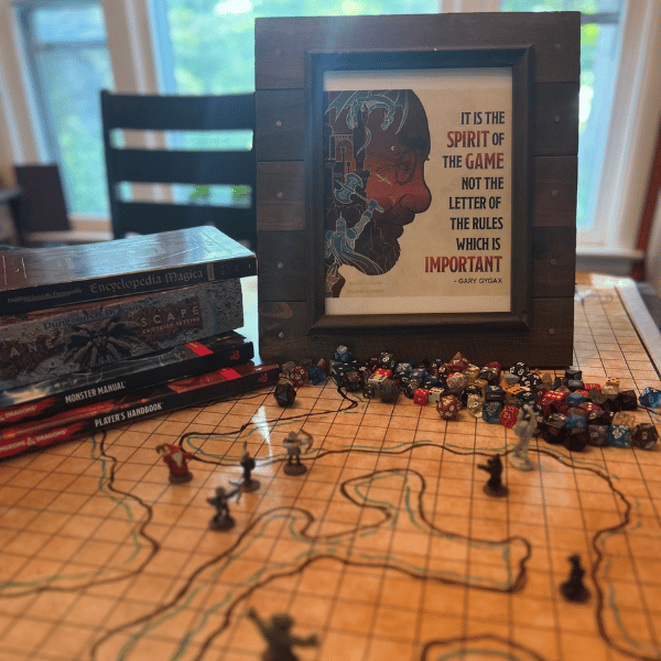 gaming table with Dungeons & Dragons books, map, dice and figurines