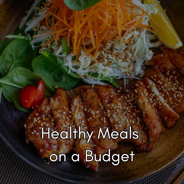 healthy meal displayed on a plate, with sliced salmon with sesame seeds and salad topped with grated carrot