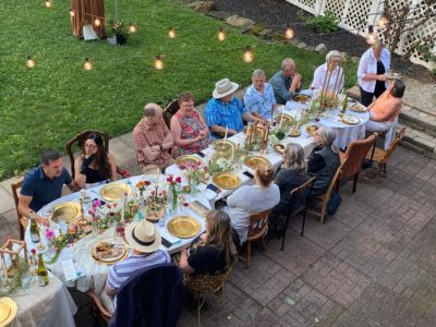 overhead view of a long dinner table outside on a patio